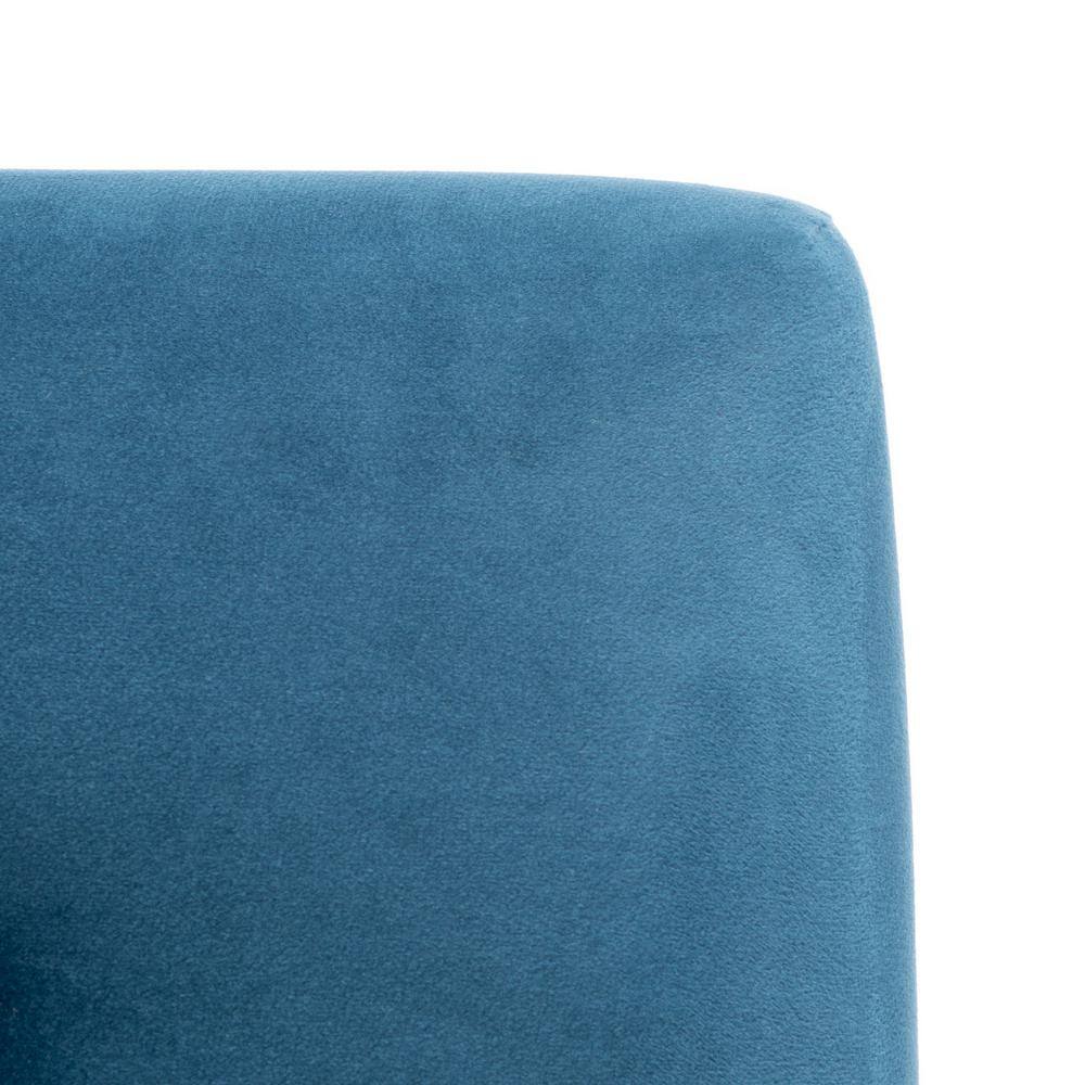 Close-up of the blue velvet fabric texture on the chair.