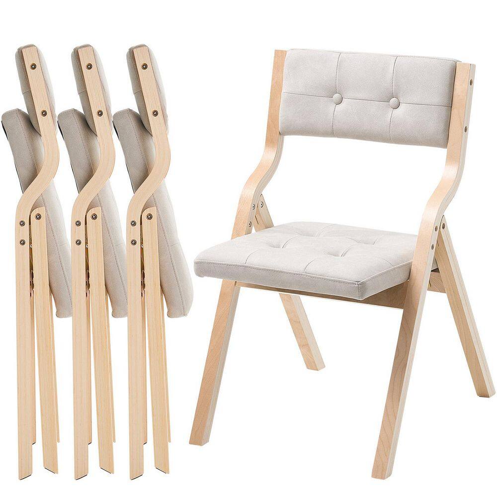 Group shot of multiple wooden folding chairs stacked.