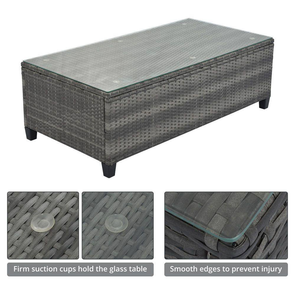 Gray wicker coffee table with tempered glass top and suction cup details