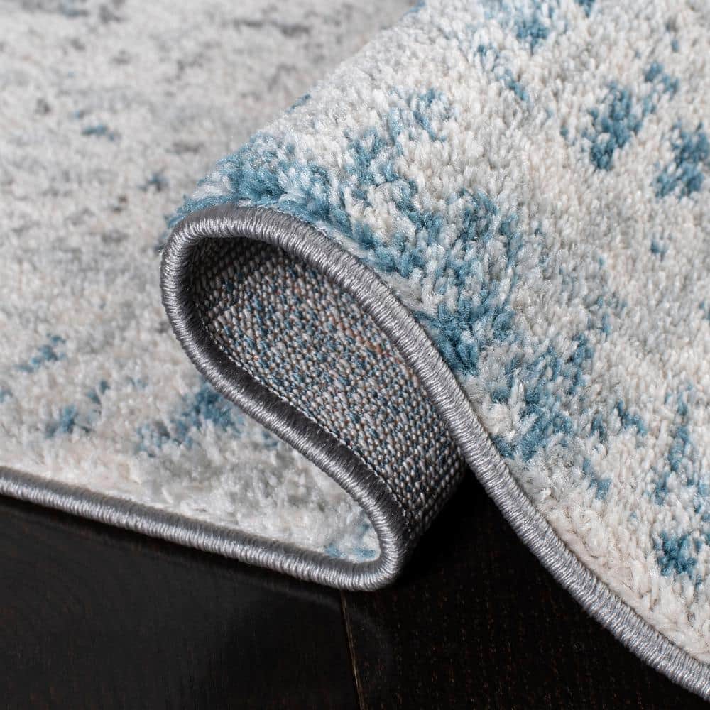 Ivory and Blue Abstract 9' x 12' Synthetic Area Rug