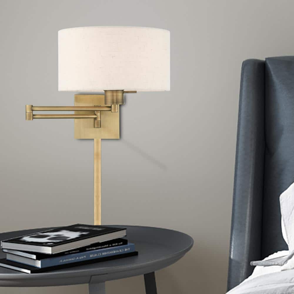 Antique Brass Swing Arm Wall Lamp with Oatmeal Shade