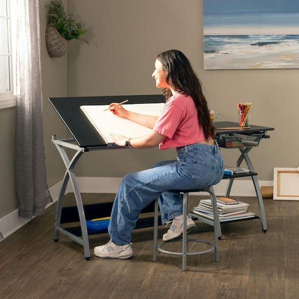 Deluxe 57.5 in. W Craft Station Silver / Black Drafting and Art Desk with Adjustable Top, Storage, and Stool
