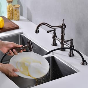 Double Handle Bridge Kitchen Faucet with Pull-Out Side Spray in Oil Rubbed Brushed