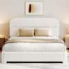 White platform bed with quilted mattress and feature panel.
