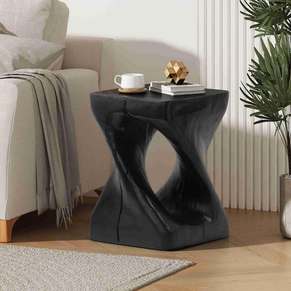 Black twist-shaped side table in a living room setting.