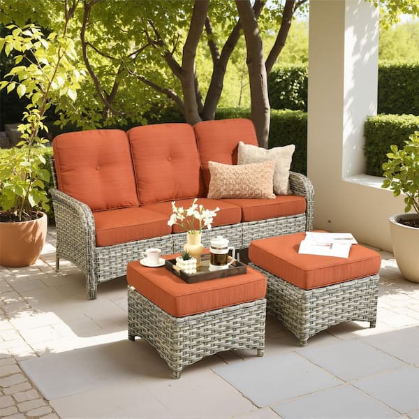 Cove Wicker Outdoor Couch with Orange Red Cushions and Ottoman
