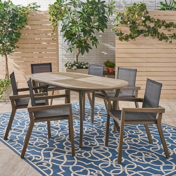 Noble House Arletta Grey Finished 9-Piece Wood Oval Outdoor Patio Dining Set
