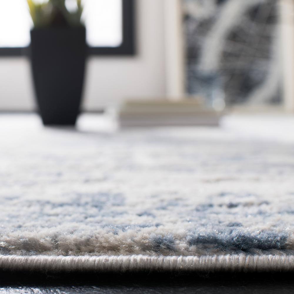 Ivory and Blue Abstract 8' x 10' Synthetic Area Rug