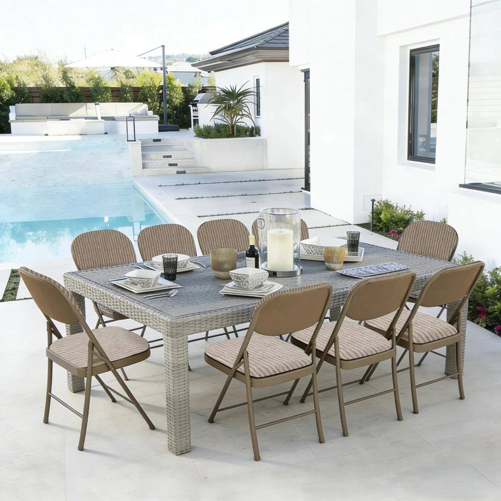 Six khaki folding chairs around a large grey outdoor dining table by a pool.