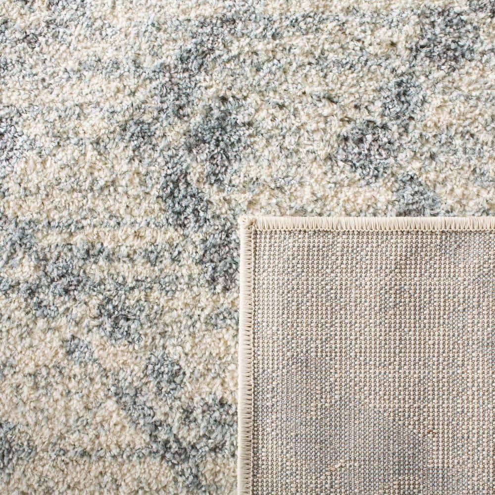 Ivory and Light Blue Geometric 9' x 12' Synthetic Area Rug