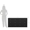 Silhouetted person next to the dresser for scale.
