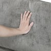 Hand touching the chenille fabric of the Lazzara Naomi accent chair