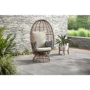 Brown Wicker Outdoor Swivel Patio Egg Lounge Chair with Beige Cushions and Black/Cream Pattern Pillows