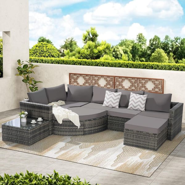 8-Piece Rattan and Metal Outdoor Sectional Set Curved Glass Top Table with Dark Gray Cushions
