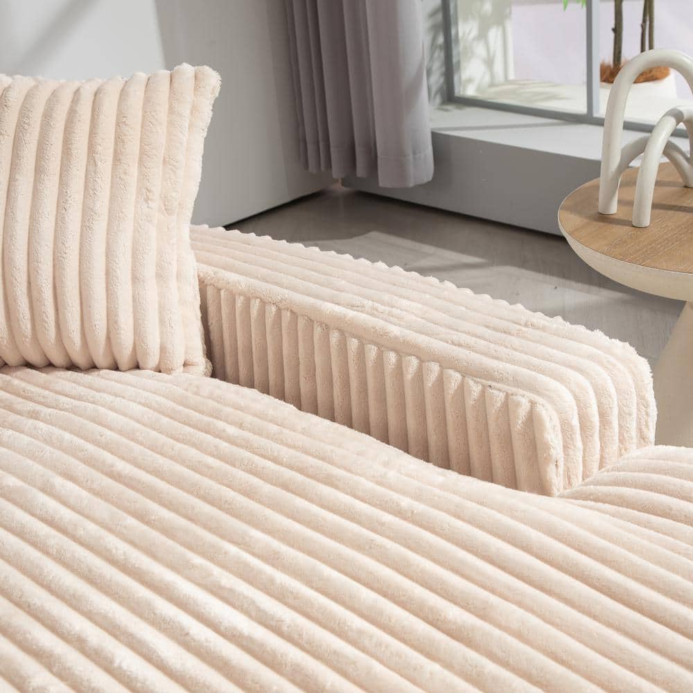 Close-up of the texture of the beige corduroy sofa.