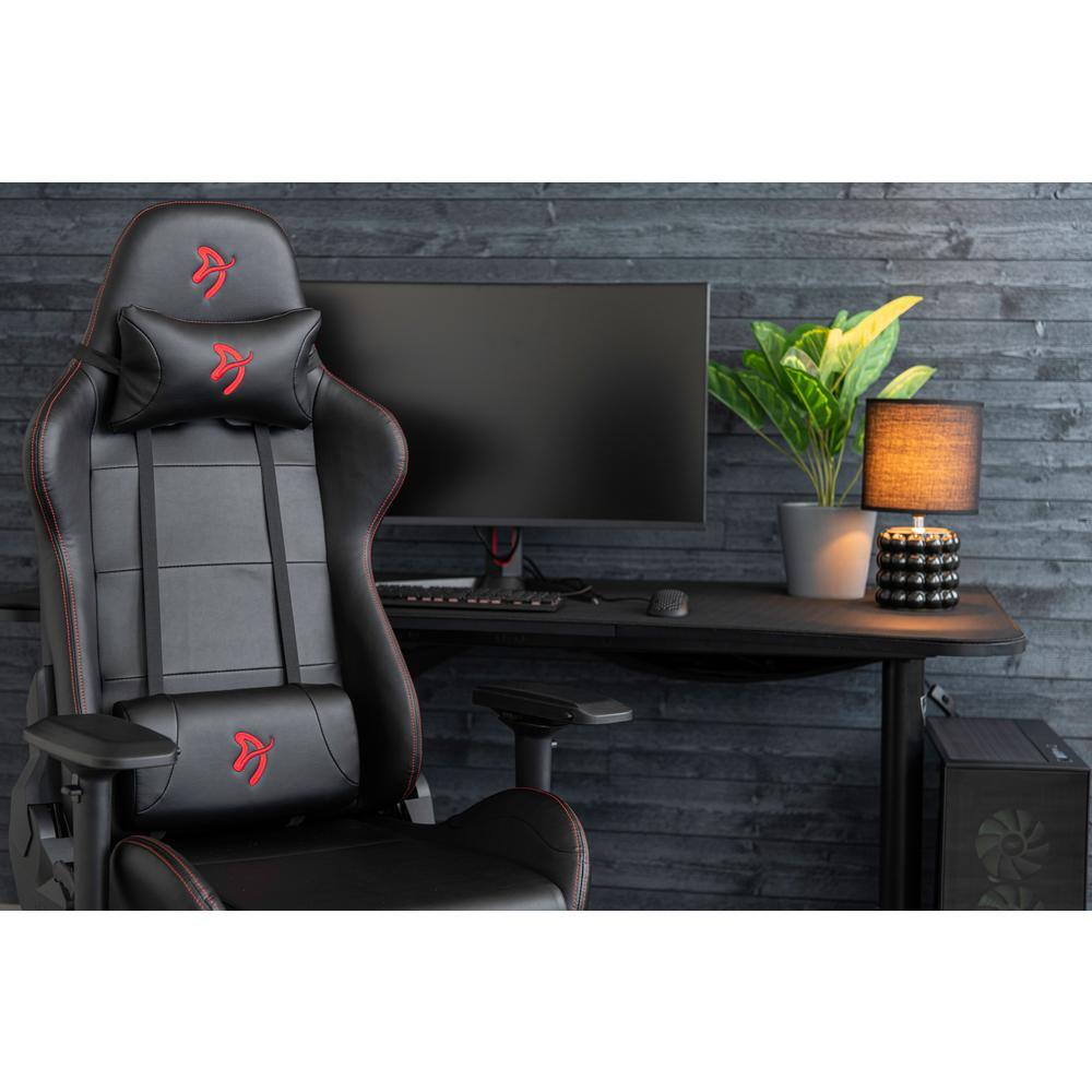 Black and red gaming chair positioned at a computer desk.