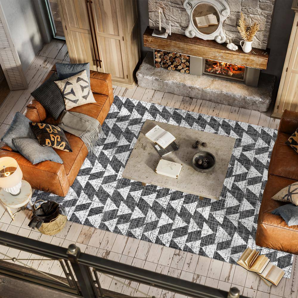 5' x 8' Black and Ivory Geometric Synthetic Area Rug