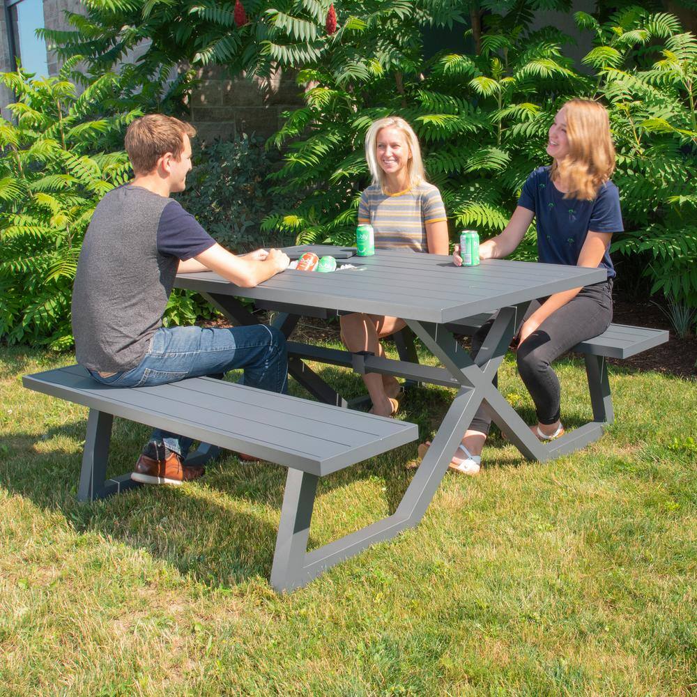 Three people sitting at a charcoal aluminum outdoor picnic table.