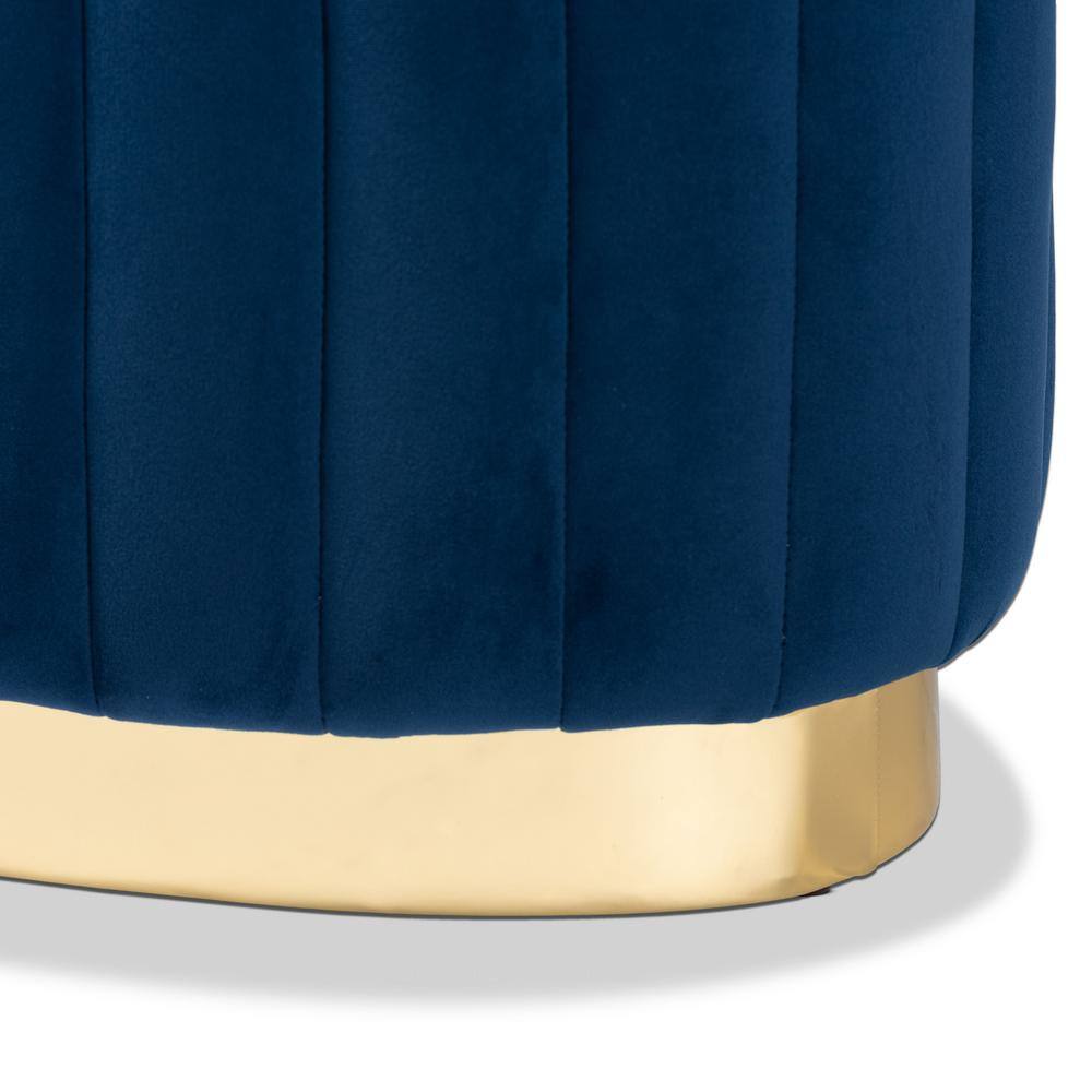 Close-up of the navy blue velvet tufting and gold base of the ottoman.