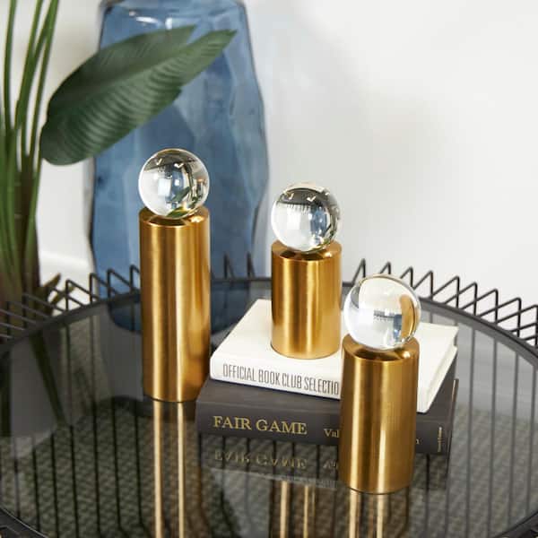 Litton Lane Gold Metal Cylinder Post Geometric Sculpture with Clear Glass Orbs (Set of 3)