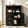 Black storage cabinet in a living room setting with open door.