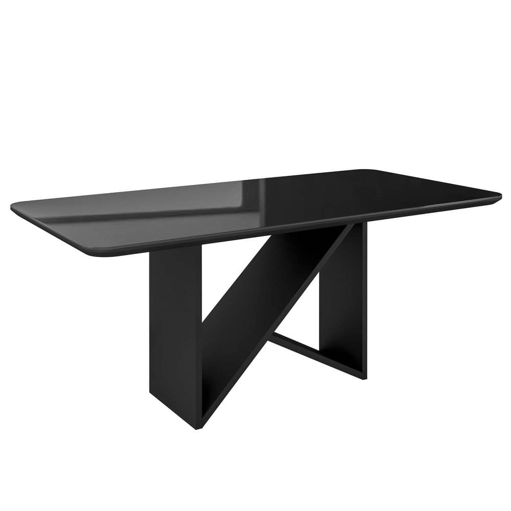 Three-quarter view of a black painted glass pedestal dining table.