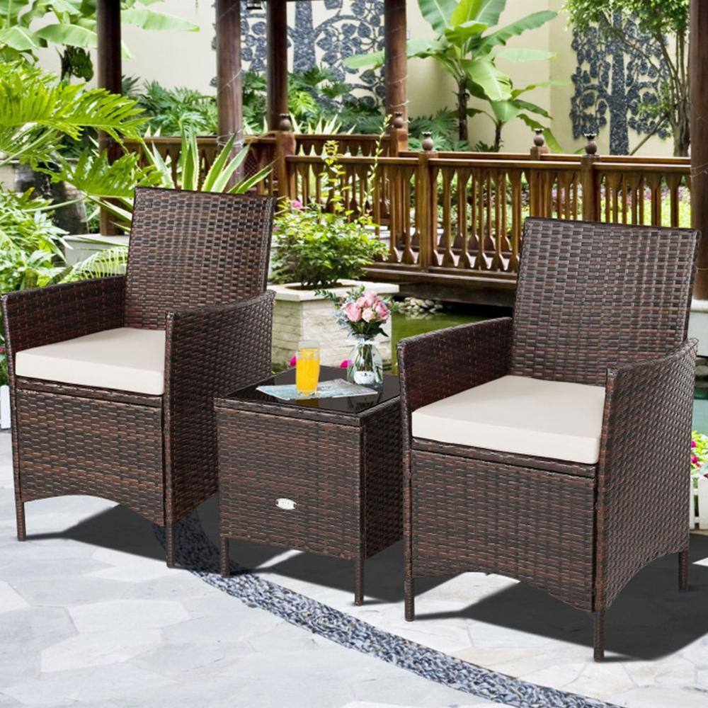 Rattan furniture set in a garden setting.