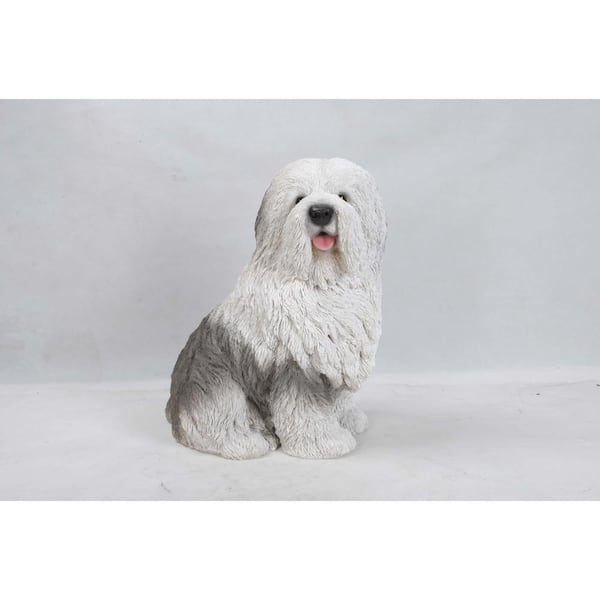 An Old English Sheepdog standing in a garden Stock Photo