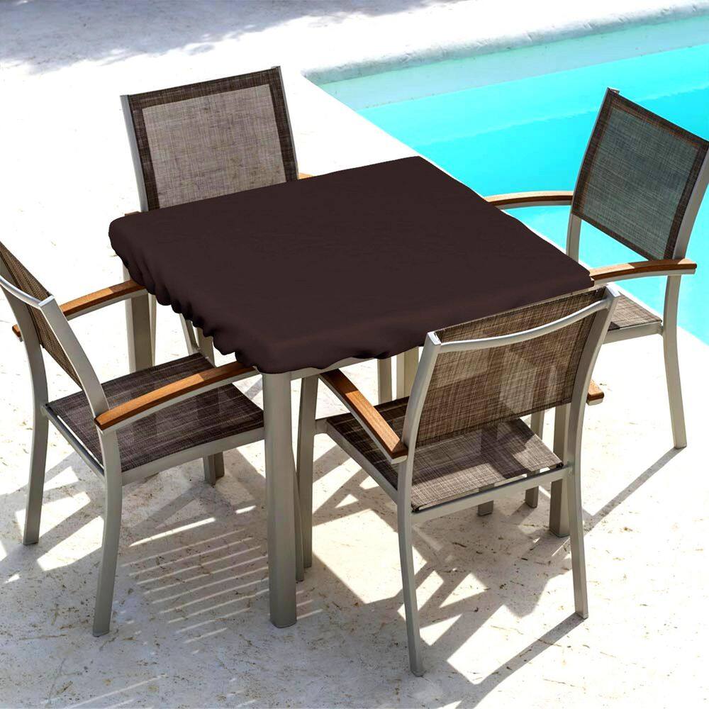 Coffee brown outdoor table top cover on a patio table with chairs by a pool.