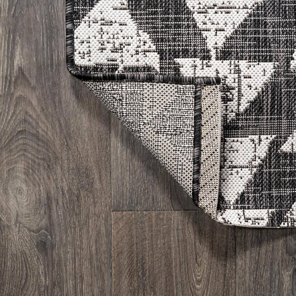 5' x 8' Black and Ivory Geometric Synthetic Area Rug