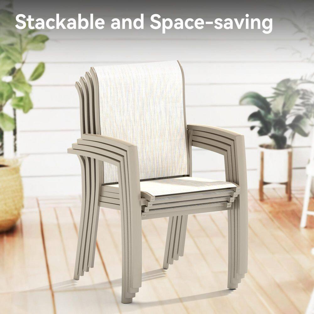 Stack of four light beige metal outdoor dining chairs.