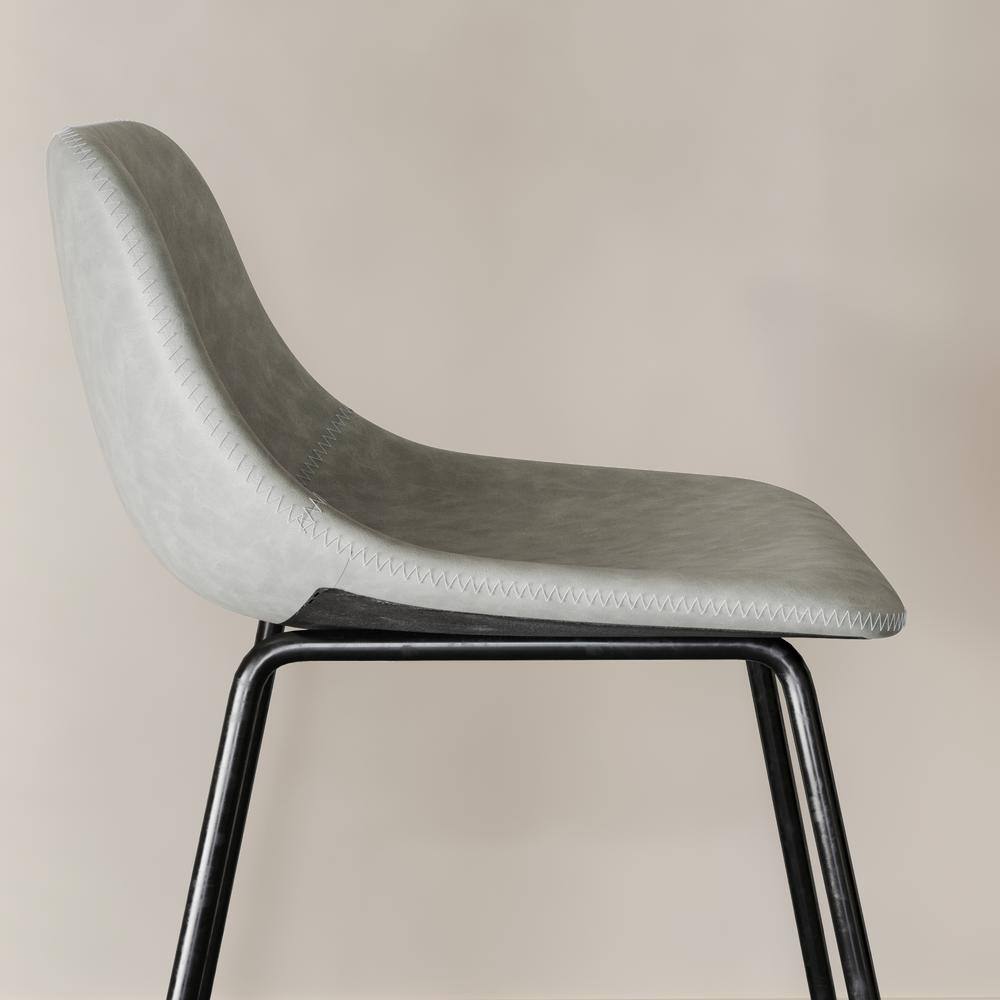 Side view of a gray faux leather bar stool seat.
