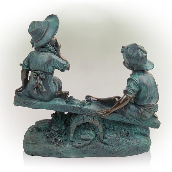 Alpine Girl and Boy Playing On Teeter Totter Statue