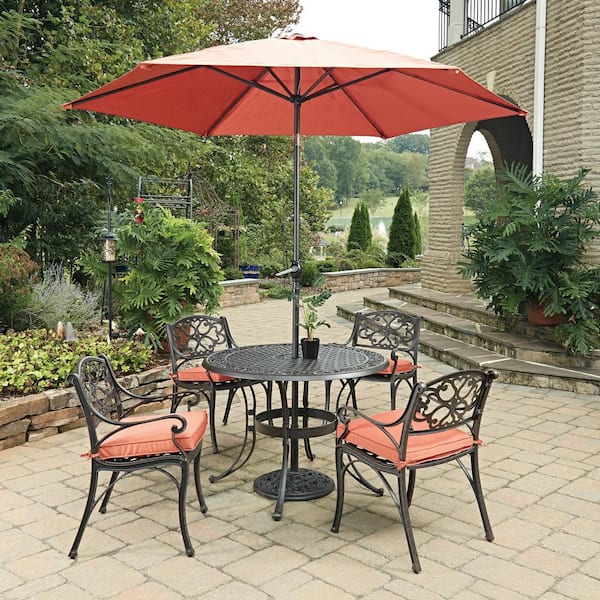 HOMESTYLES Sanibel Rust Bronze 7-Piece Cast Aluminum Round Outdoor Dining Set with Coral Cushions and Umbrella