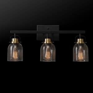 Rockhampton 24 in. 3-Light Matte Black Vanity Light with Matte Brass Accent and Seeded Glass Shades