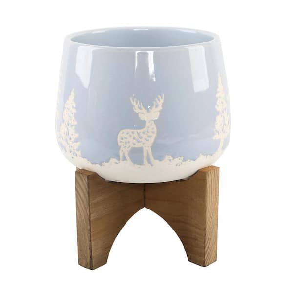 Flora Bunda 6.75 in. Light Blue Ceramic Christmas Trees and Deer Textured Planter on Wood Stand