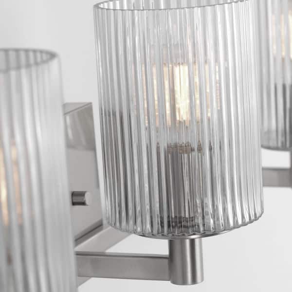 Generation Lighting - Lando 24.625 in. W 3-Light Brushed Steel Bathroom Vanity Light with Clear Fluted Glass Shades and LED Bulbs Included