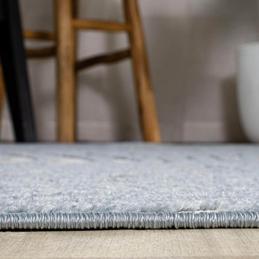 Light Blue and Ivory Abstract 4' x 6' Synthetic Area Rug