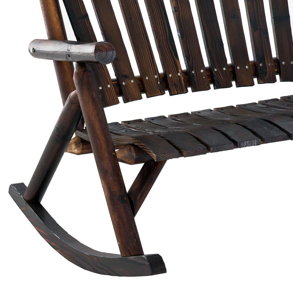 Close-up of the armrest and rocking base of a brown wooden Adirondack chair.