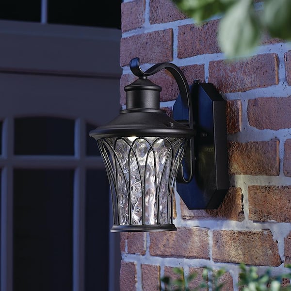 Avia Falls 12.13 in. Black Dusk to Dawn Small LED Outdoor Wall Light Fixture Sconce with Clear Water Glass