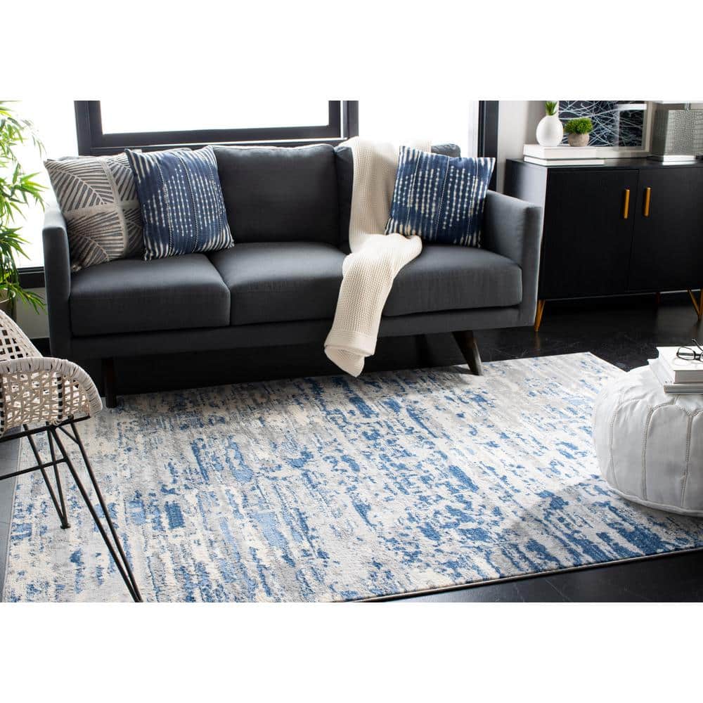Ivory/Blue Abstract Synthetic 8' x 10' Easy Care Area Rug