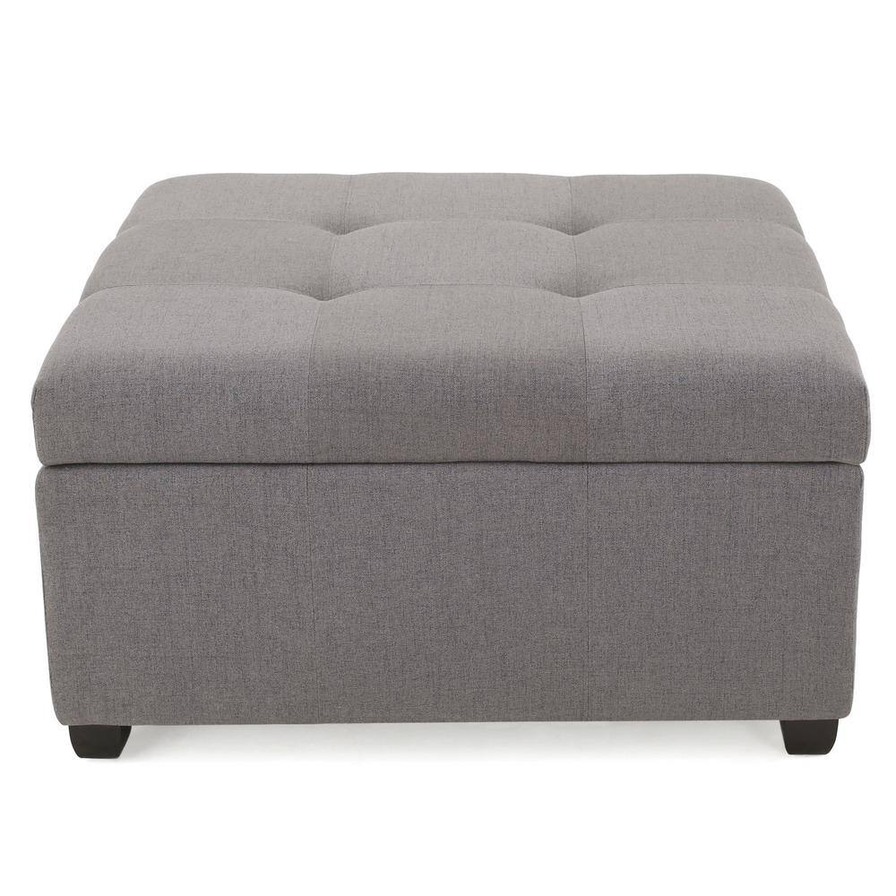 Front view of a light grey tufted storage ottoman bench.