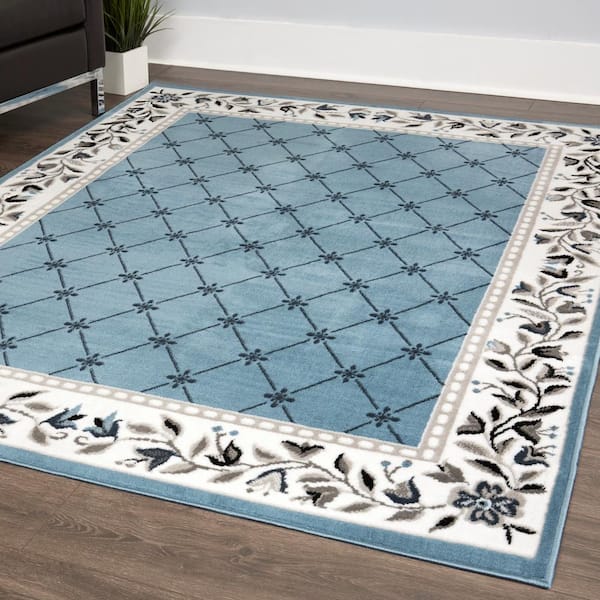 https://images.thdstatic.com/productImages/9f489c3a-496c-44f0-a328-160fc801f752/svn/blue-ivory-home-dynamix-area-rugs-2-7015-327-e1_600.jpg