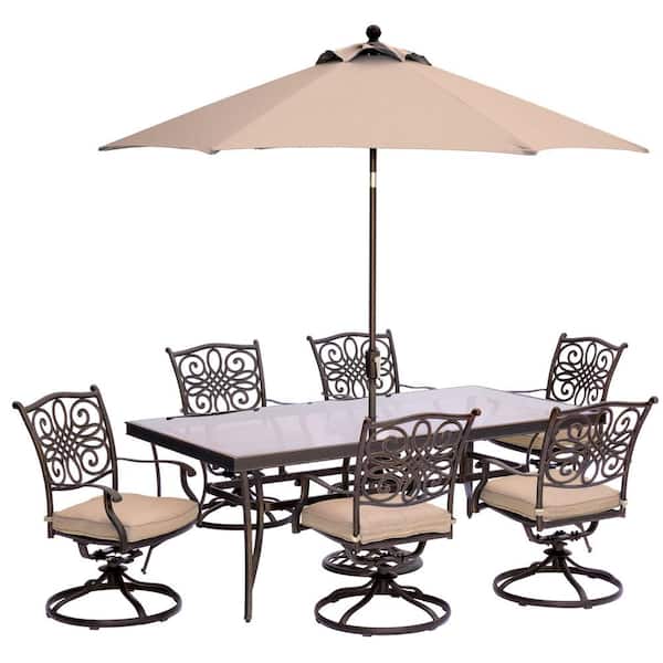 Hanover Traditions 7-Piece Outdoor Dining Set with Rectangular Glass Table, Swivels, Umbrella and Base with Natural Oat Cushions