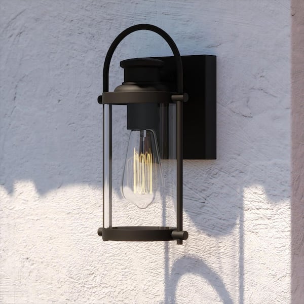 VAXCEL Winfield 1 Light Dusk to Dawn Matte Black Outdoor Wall Lantern Clear Cylinder Glass