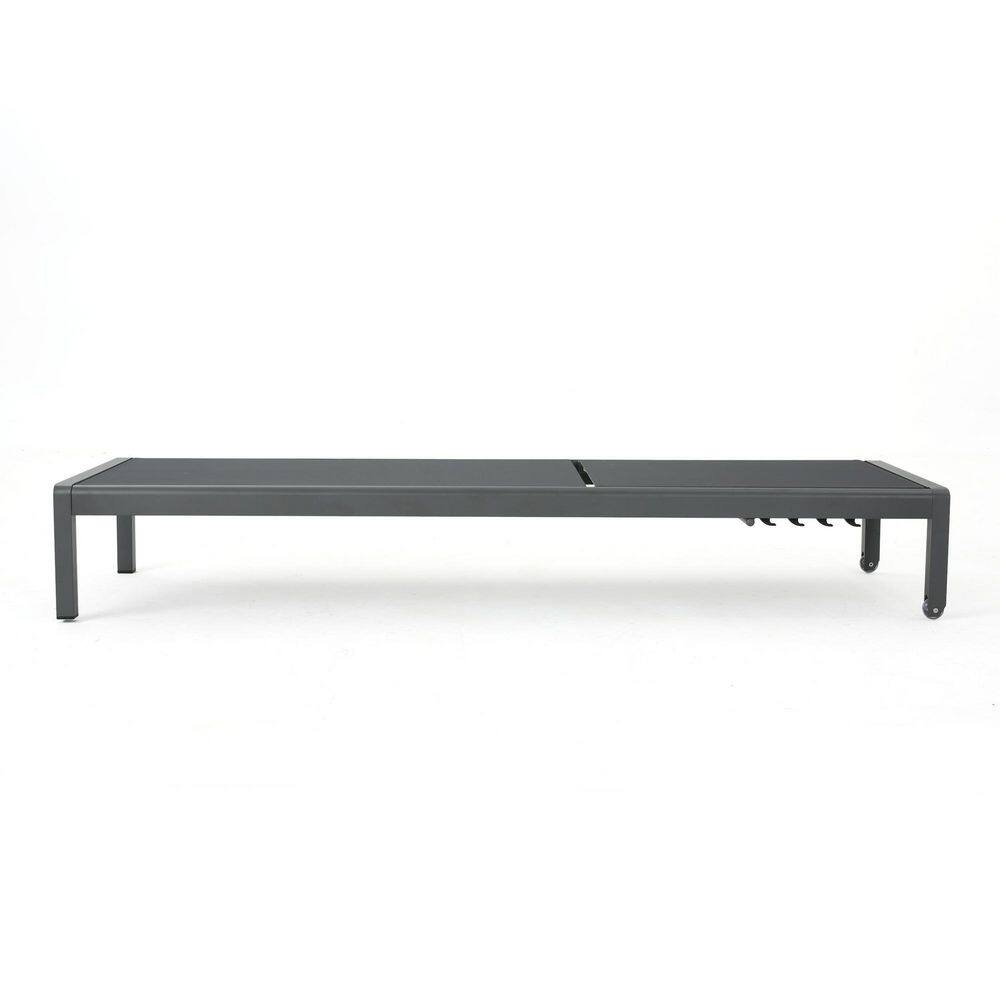 Gray metal outdoor chaise lounge viewed in profile.