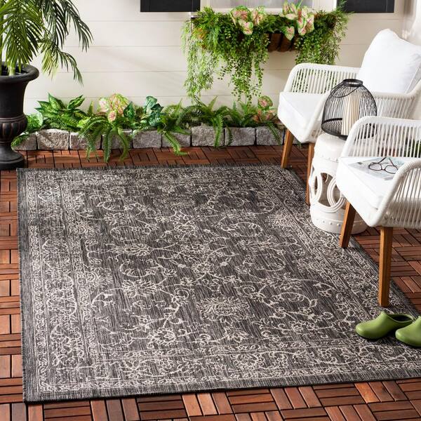 https://images.thdstatic.com/productImages/a11981ce-163a-4aad-be31-1d92b15018b7/svn/black-ivory-safavieh-outdoor-rugs-cy8680-36621-3-e1_600.jpg