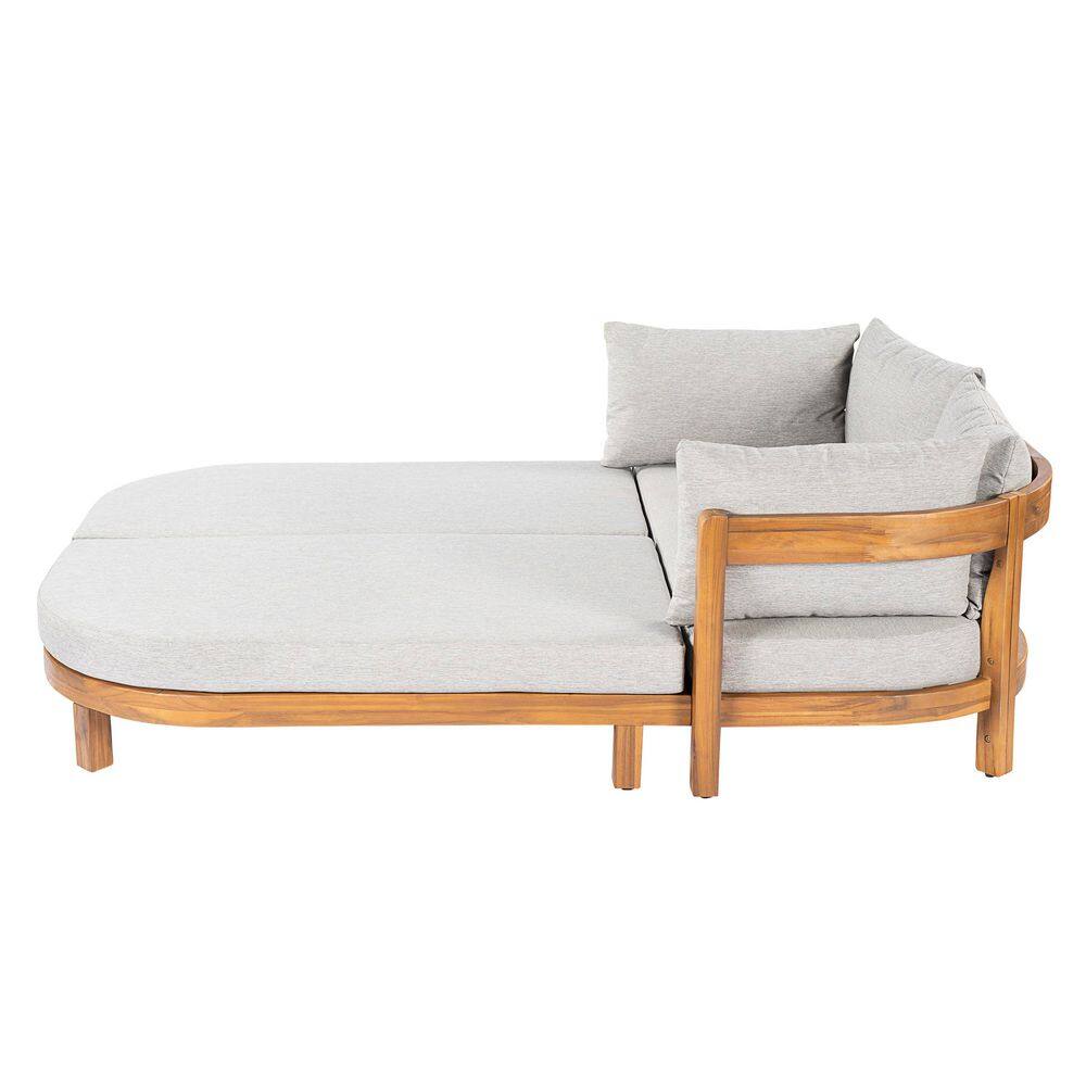 Side view of a teak wood outdoor day bed with light grey cushions.