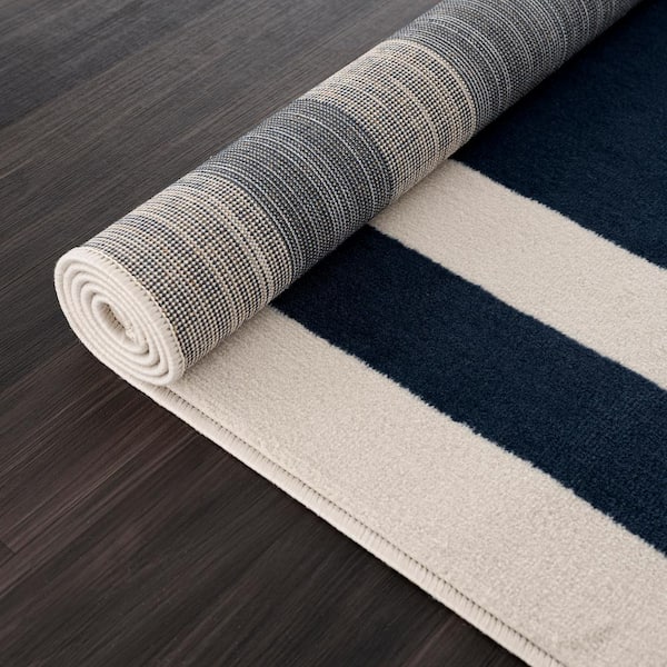 https://images.thdstatic.com/productImages/a3614e9e-033a-4bec-a56d-b737dd10c6fb/svn/navy-blue-cream-camilson-area-rugs-cry1003-nvy-2x7-hd-66_600.jpg