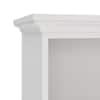Close-up of the crown molding top of a white bookcase.
